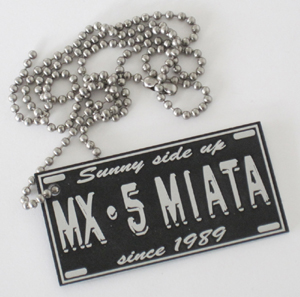 Logo tag with 'MX-5 Miata - Sunny side up since 1989' emblem